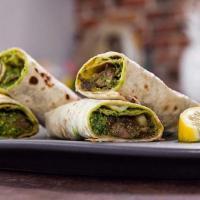 Lamb Seekh Kabob Kati Roll · Ground lamb marinated in spices, cooked in a tandoori oven, and
served with a creamy cucumbe...