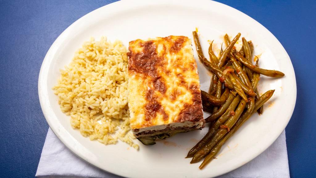 Moussaka · Layers of eggplant, potatoes, seasoned ground beef topped w/bechamel sauce. Served w/rice & green beans. Consuming raw or undercooked meats, poultry, seafood,shellfish or eggs may increase your risk of foodborne illness, especially if you have certain medical conditions.