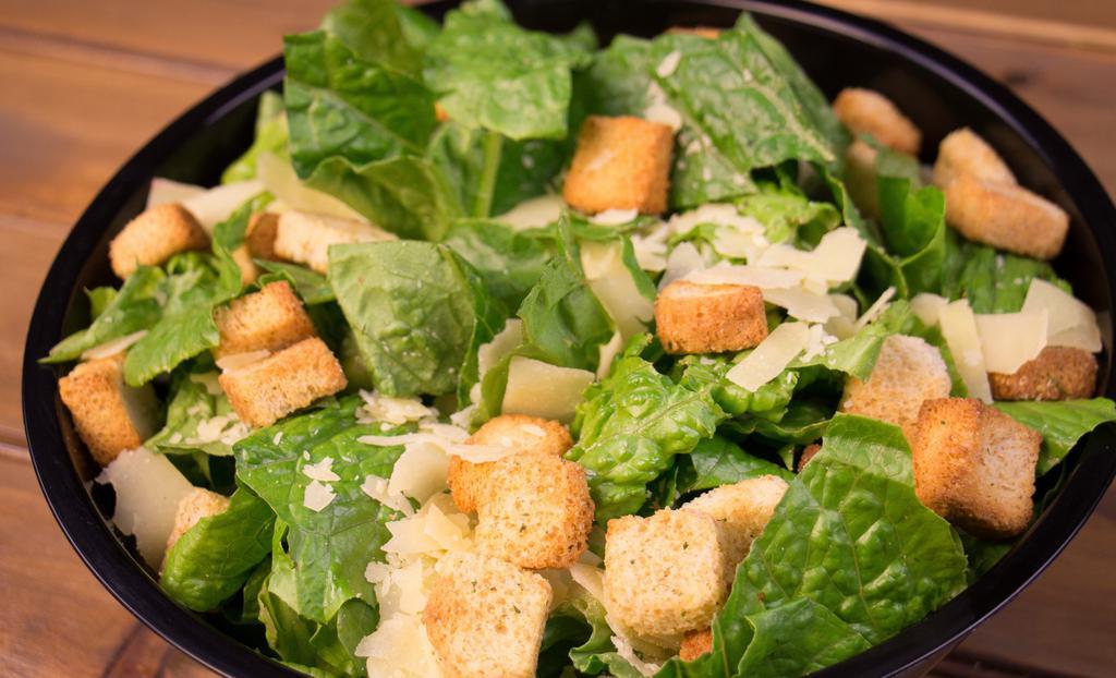 Caesar Salad · Fresh romaine tossed with shredded Parmesan cheese, garlic croutons, and creamy Caesar dressing. Add grilled chicken or 8 oz salmon for an additional charge.