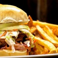 Smoked Beef Brisket Sandwich · Hickory smoked beef brisket topped with raw onion, Texas barbeque sauce and cole slaw.