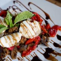 Portabella · Grilled portabella mushroom with onions and roasted peppers topped with mozzarella and drizz...