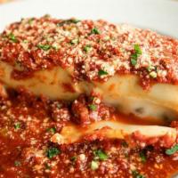 Lasagna · Layers of oven-baked lasagna pasta stuffed with an egg, parmigiana, and ricotta mixture with...