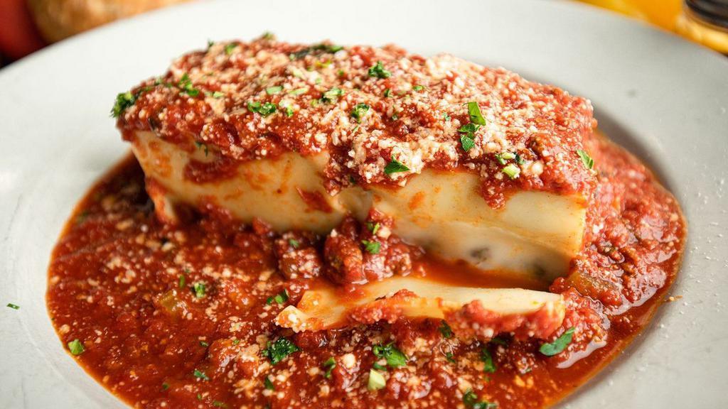 Lasagna · Layers of oven-baked lasagna pasta stuffed with an egg, parmigiana, and ricotta mixture with ground beef topped with meat sauce and mozzarella.