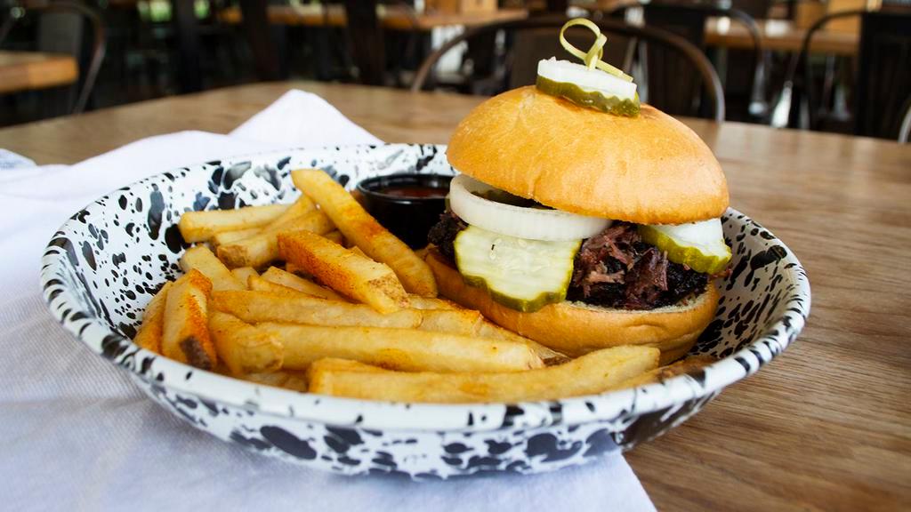 Brisket Sandwich · Topped with pickles and onions served on a butter toasted bun. Choose between Sliced or Chopped.