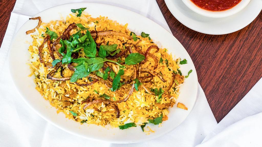 Chicken Biryani · Marinated chicken cooked with basmati rice and herbs, tossed with fried onions.