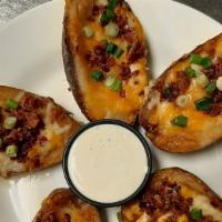 Potato Skins · Gluten free. Filled with cheddar and jack cheese, then topped with bacon crumbles and chives...