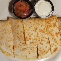 Quesadilla · A huge flour tortilla stuffed with cheddar and jack cheese and grilled golden brown. Served ...