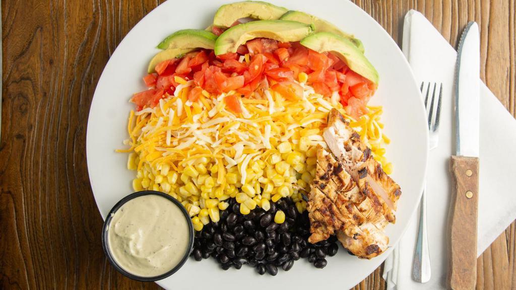 Southwestern Salad · Gluten free. Vegetarian. Our fresh greens topped with black beans, avocado, cheddar and jack cheeses, corn, tomato. Served with our spicy avocado ranch.