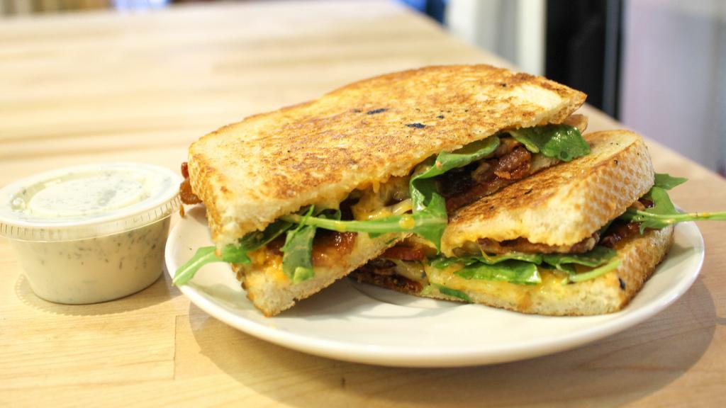 Spicy Mama Sandwich W/ Spicy Ranch · Roasted Bacon, House Blend Cheeses, Arugula, and housemade Chili-Jalapeno Aioli on Farm-to-Market Sourdough. Served with Jalapeño Ranch for dipping. Box & utensils are compostable.