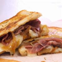 Rosemary Brie Panini Sandwich · French Brie, Caramelized Onion, and Prosciutto grilled with Rosemary Butter on Farm-to-Marke...