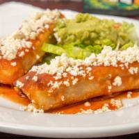 Taquitos Salvadoreños* · Two fried corn tortillas rolled and
stuffed with your choice of beef or
chicken. Served with...