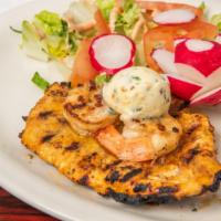 Pollo Sazon Latina* · Marinated grilled chicken breast topped with shrimp, garlic butter and served with Spanish r...