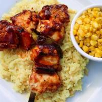 Bbq Chicken Skewers · Twin bbq chicken skewers served over rice pilaf and roasted corn