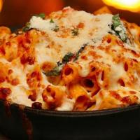 Baked Rigatoni · Baked rigatoni with sausage in a pink vodka cream sauce tipped with ricotta cheese