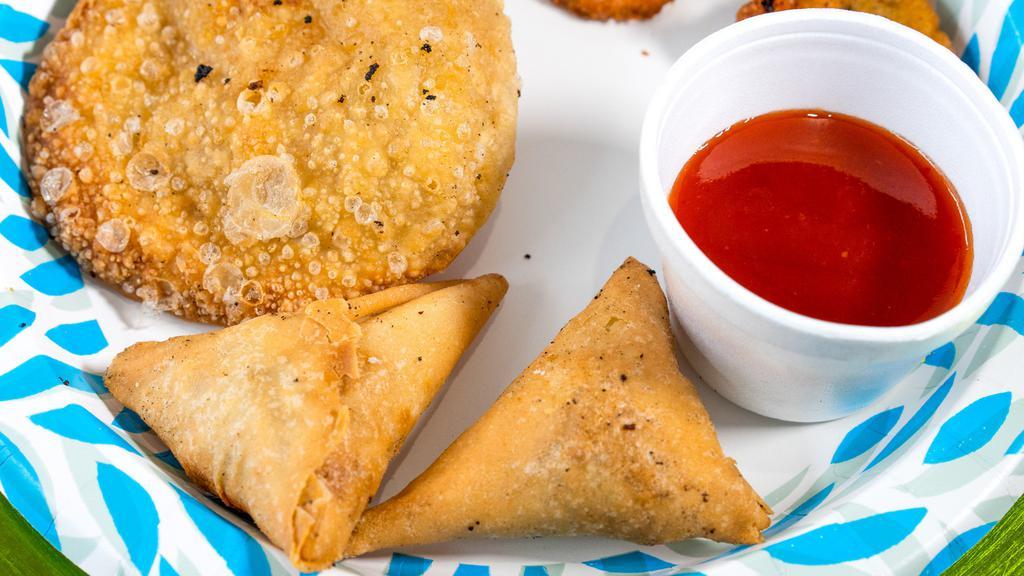 2 Pieces Of Vegetable Samosa · Deep fried cone pastry filled with potatoes and green peas.