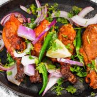 Tandoori Chicken Salad · Succulent pieces of tandoori chicken (white meat) tossed in a medley of fresh greens and ser...