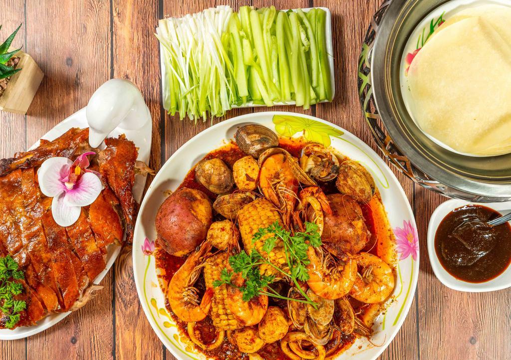 Peking Duck And Seafood · Includes: 1/2 Duck, 1/2 lb Jumbo Shrimp with Heads, 1/2 lb Baby Clams, 1/2 lb Squid, 4pc Lobster Balls, 1/2 lb Black Mussels, 2pcs Corn on the Cob, 2 Potatoes, 6pcs Pancakes, Scallion & Cucumber slices, and Hoisin Sauce.