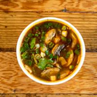 Tom Yum · Lemongrass, lime and chili paste based soup with mushrooms, tomato, cilantro, and green onio...