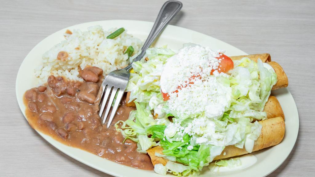Flautas · 5 fried tacos stuffed with chicken and topped with lettuce, tomato, sour cream, and cheese. served with rice and beans.