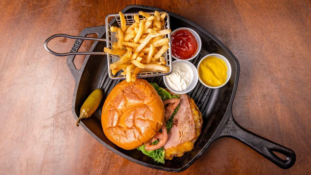 El Manito Burger · 1/2 lb. Ground beef patty, ham, lettuce, mayo, tomato, mustard , pickles, ketchup, Monterey Jack and cheddar cheeses. Served with a jalapeño and  French Fries on the side.