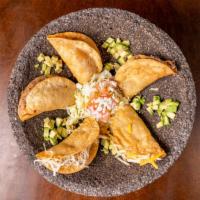 Tacos Dorados (Crispy) · 5 Corn tortillas filled with your choice of meat, then fried until nice and crispy, topped w...