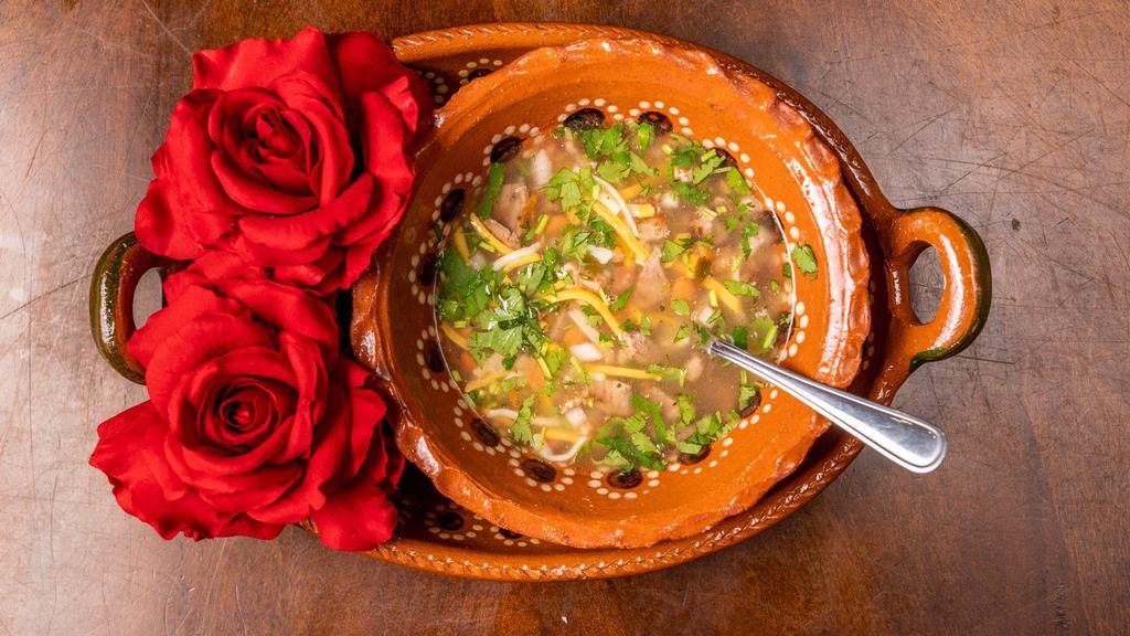 Frijoles Preparado · Our Delicious Charro beans, topped with Asada and cheese.
