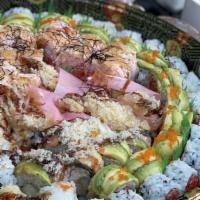 Angry Dragon · Shrimp tempura, spicy tuna, sliced papaya, king crab salad on top. Served with nuta sauce.