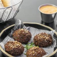 Falafel (4 Pcs) · Deep fried patties made from spiced and grounded chick-peas mixed with parsley and onions, s...