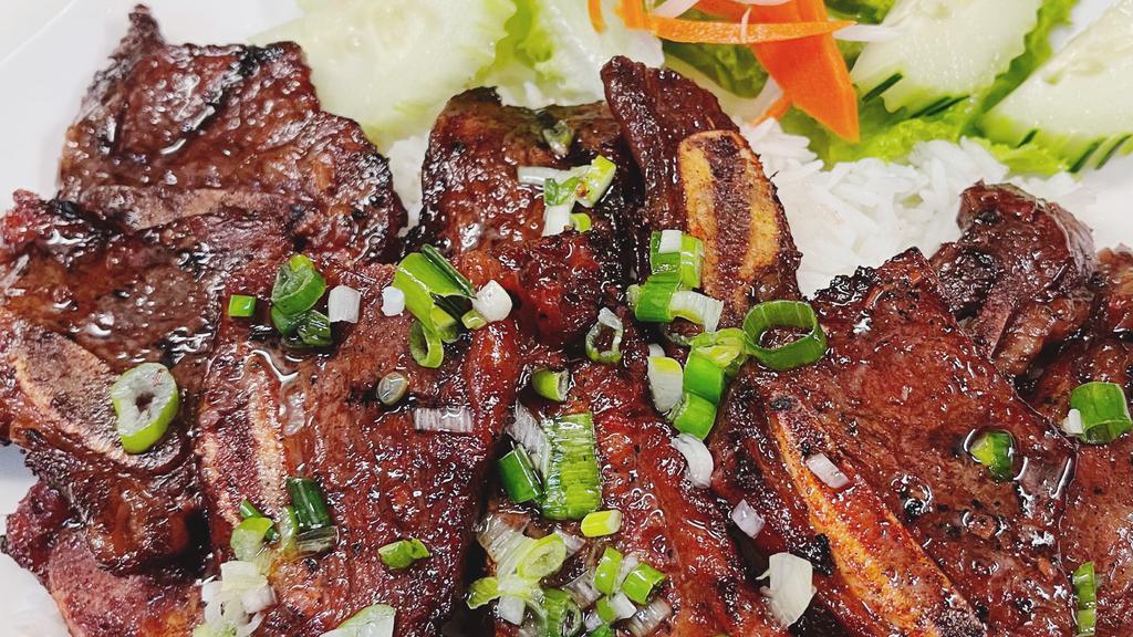 Beef Short Ribs / Cơm Sườn Bò Nướng · Steamed rice with grilled beef short ribs, lettuce, cucumber served with sweetened fish sauce. Add meat for an additional charge.