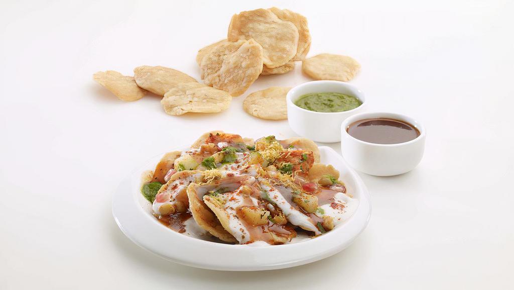 Papri Chat · Crisply fried dough wafers served with boiled chickpeas, boiled potatoes, yogurt and honey chilly paste (chutney), topped with chaat masala.
