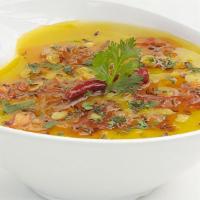 Dal Tadka · Comfort food-boiled yellow lentil spiced up with Indian herbs. Come with Rice