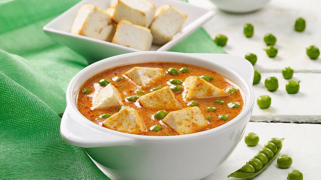 Matar Paneer · Tomatoes puree simmered in onion ginger paste mixed with spices and cubes of Indian Cottage cheese. Come with Rice