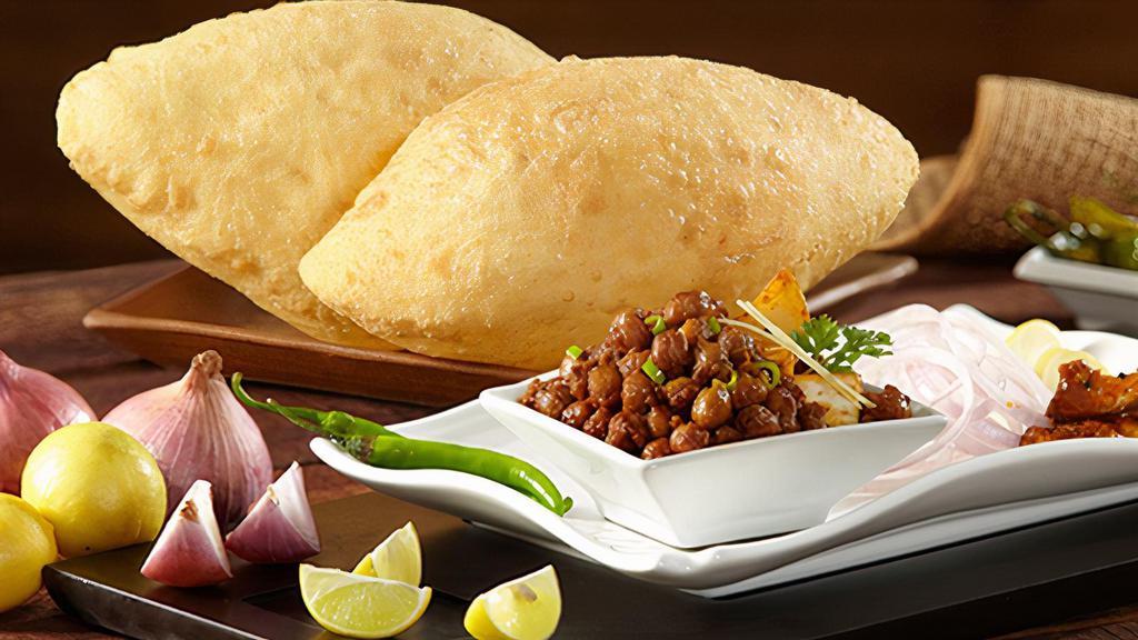 Chole Bhatura · Deep fried puff bread served with chickpea masala portion.
