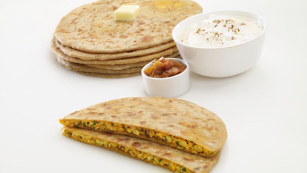 Stuffed Paratha · Served with raita shallow fry whole wheat bread stuffed with a mixture of Paneer (Cottage cheese), aloo (potato) or gobhi (cauliflower).