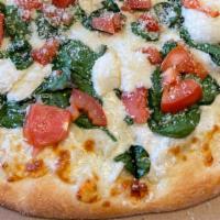 Spinach White Pizza · Fresh homemade dough and extra virgin olive oil topped with organic mozzarella and ricotta c...