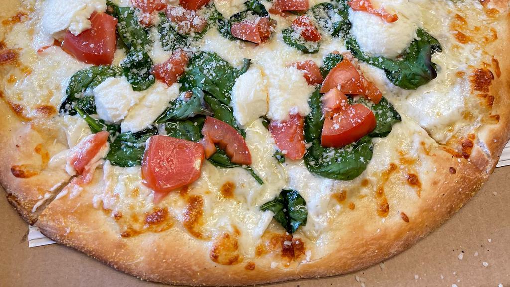 Spinach White Pizza · Fresh homemade dough and extra virgin olive oil topped with organic mozzarella and ricotta cheeses, fresh spinach, garlic and tomatoes