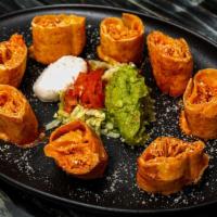 Chicken Taquitos · Lightly fried flour tortilla filled with shredded
chicken and melted cheese.
Topped with THE...