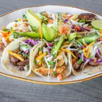 Street Tacos · Tacos are served with refried beans, Spanish rice, onions, cilantro, lime, and habanero sals...