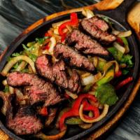 Fajitas *Gf · Choice of meat sautéed with grilled marinated onions, bell peppers, in a light red sauce. Co...