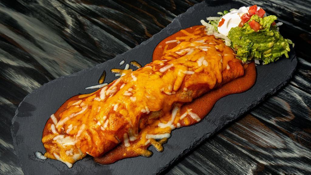 Big Boy Burrito · Large flour tortilla smothered in classic red
enchilada sauce and melted cheese. Filled with
Spanish rice, refried beans and your choice
of chicken or ground beef. Served with lettuce,
tomato, and THE WORKS