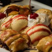 Banana Chimi · Flour tortilla filled with banana, cinnamon,
honey and sugar, rolled and lightly fried. Serv...