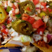 Super Nachos · Tortilla Chips, topped with Nacho Cheese Sauce, lettuce, sour cream, Jalapeños, Pico de Gall...