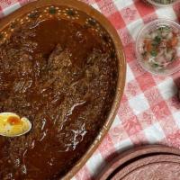 Tazón De Birria / Birria Bowl · Guiso de carne cocinado en salsa de adobo y servido con caldo de consomé. / Meat stew cooked...