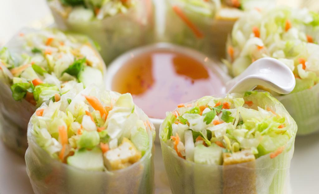 Summer Rolls · Hand-rolled soft rice paper stuffed with fresh iceberg lettuce, tofu, cucumber, carrot and cilantro, served with sweet and sour dipping sauce.