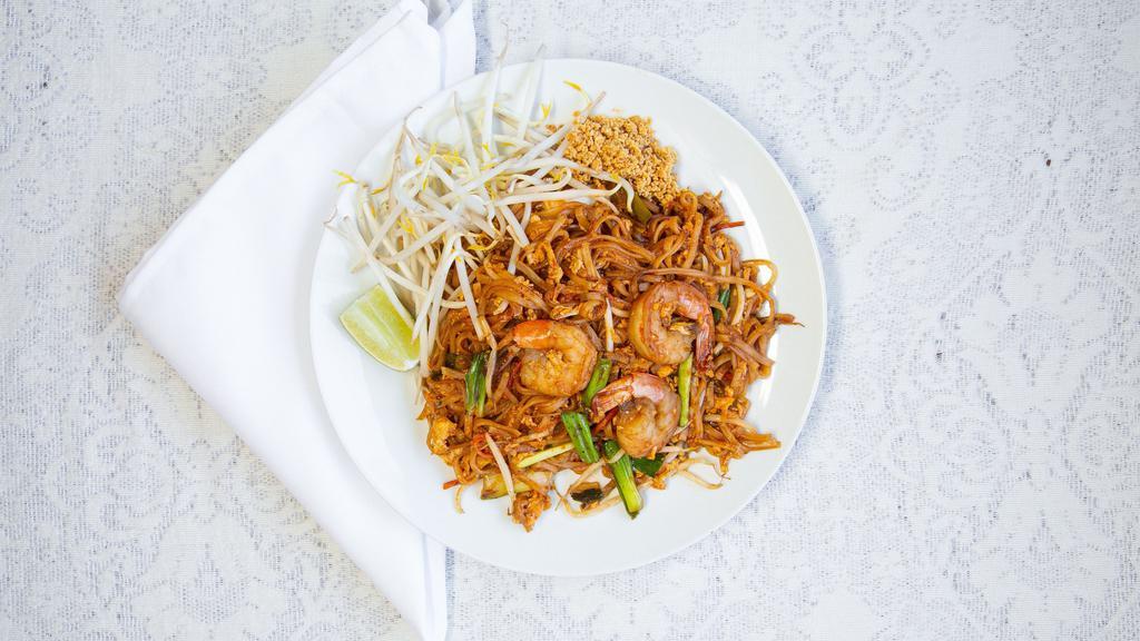 Pad Thai Noodle · Vegetarian. Pan-fried noodles with egg in tamarind sauce with bean sprouts and carrots,
served with ground peanuts and a lime wedge.