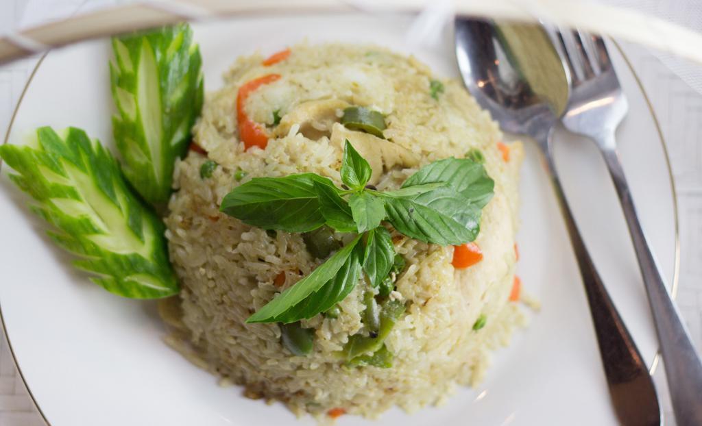 Green Curry Fried Rice · Gluten free. Spicy. Vegan. Jasmine rice pan-fried with green coconut curry sauce and bell peppers, carrots, peas, bamboo shoots and Thai basil.