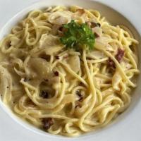Spaghetti Carbonara · Spaghetti sautéed with bacon, egg, and onions in a parmigiana cream sauce.