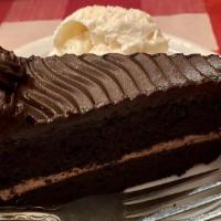 Chocolate Fudge Cake · A moist dark chocolate cake with fudgy filling, covered with chocolate ganache frosting, top...