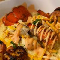 Lobster Crab And Shrimp Grits · Cajun cheesy  grits topped with lobster, crab, shrimp, peppers, and Turkey sausage finished ...