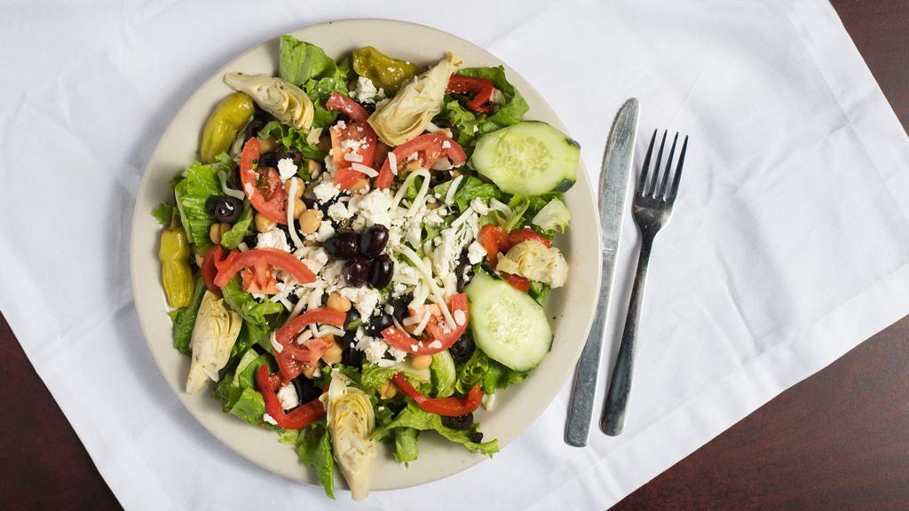 Greek Salad · Romaine, lettuce, tomatoes, chickpeas, green peppers, artichokes, pepperoncini peppers, Feta cheese, carrots and kalamata olives.